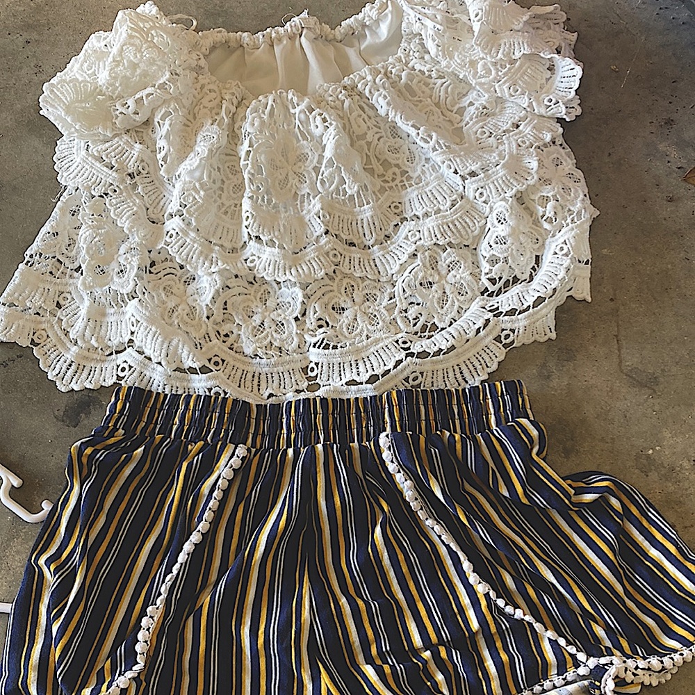 White, ruffled, cropped blouse and elastic shorts.